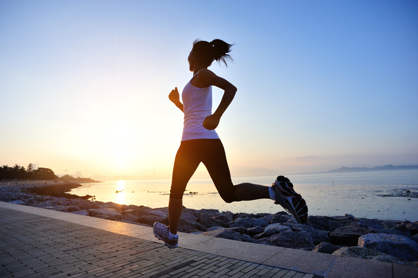 healthy lifestyle asian woman running at sunrise seaside